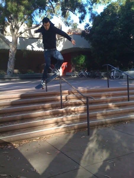 Skateboarder mid-air over the stairs at UCSB